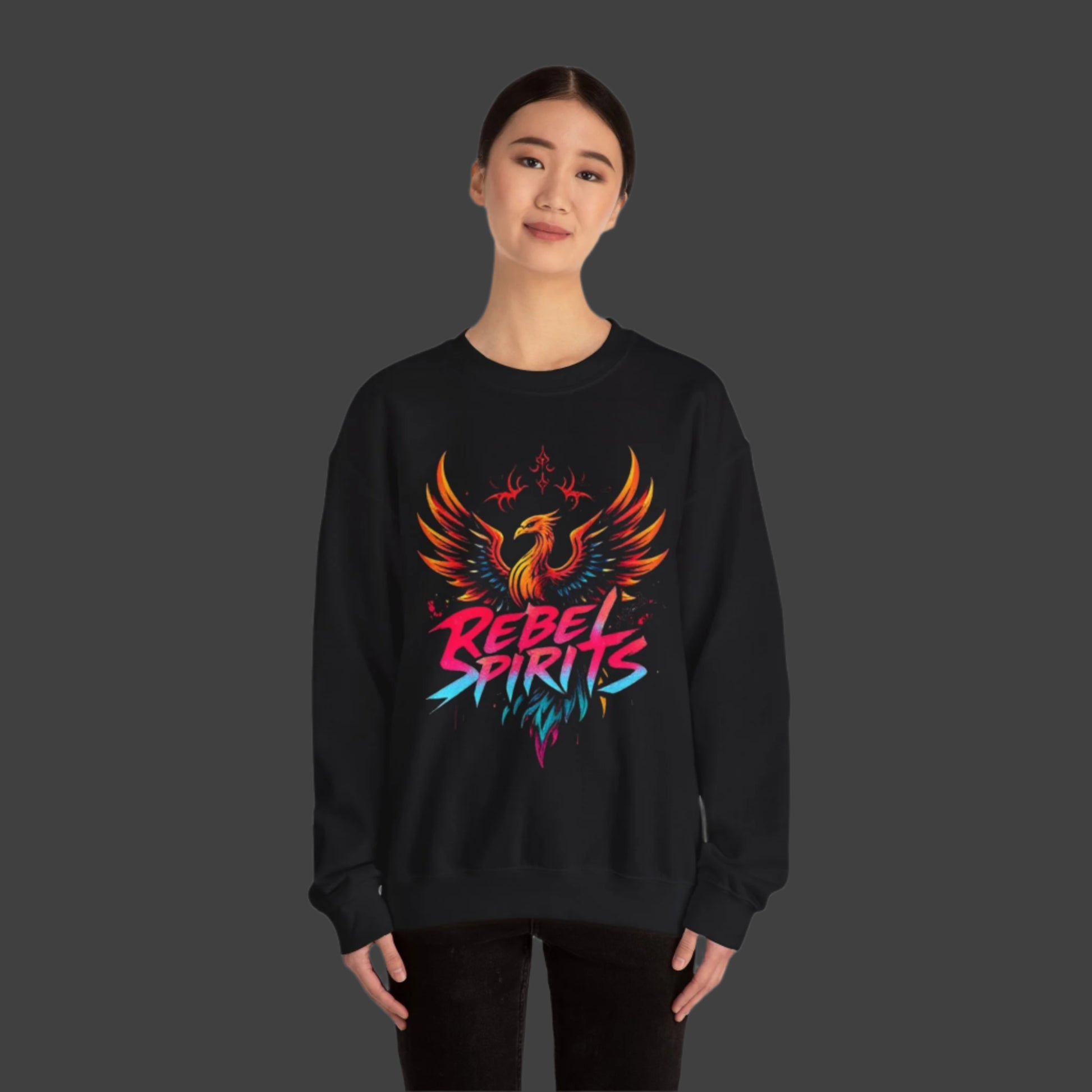 Person wearing a black sweatshirt with a colorful phoenix design and 'Rebel Spirits' text on a white background