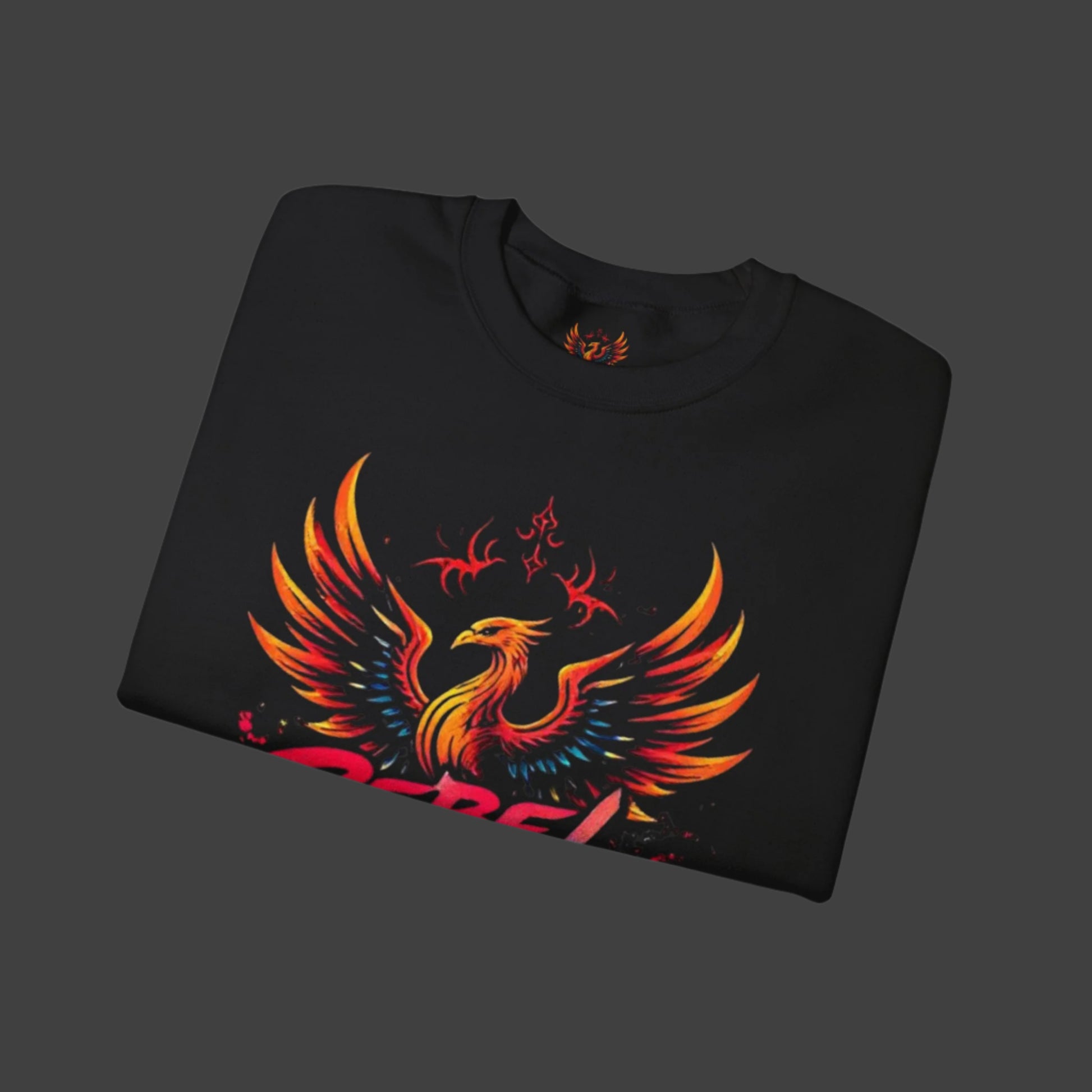 Folded black sweatshirt with a colorful phoenix design on a white background